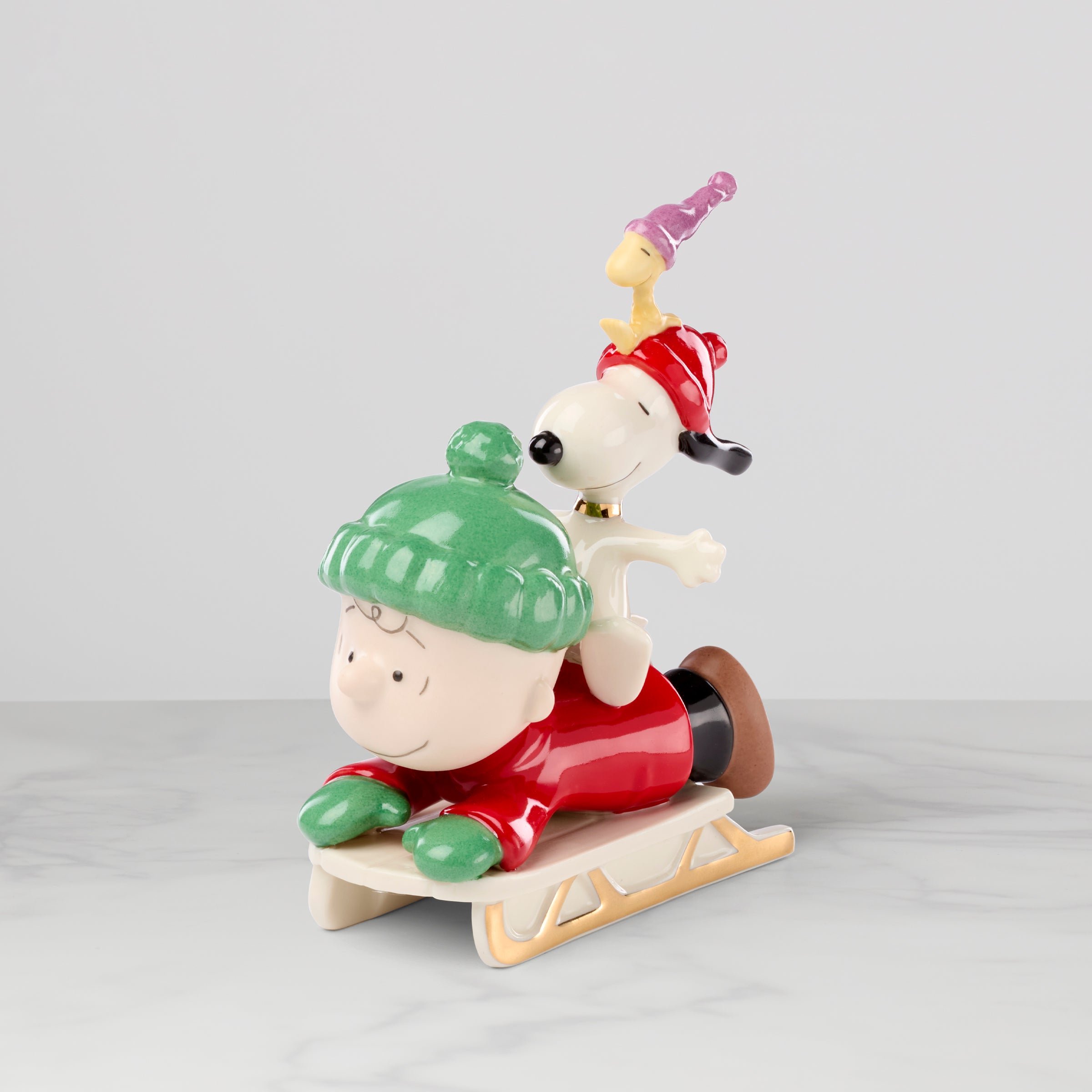 Porcelain Snoopy & Woodstock Sledding Figurine with Gold Accents